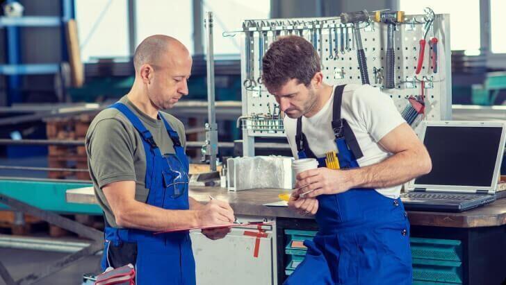 Men looking at clipboard